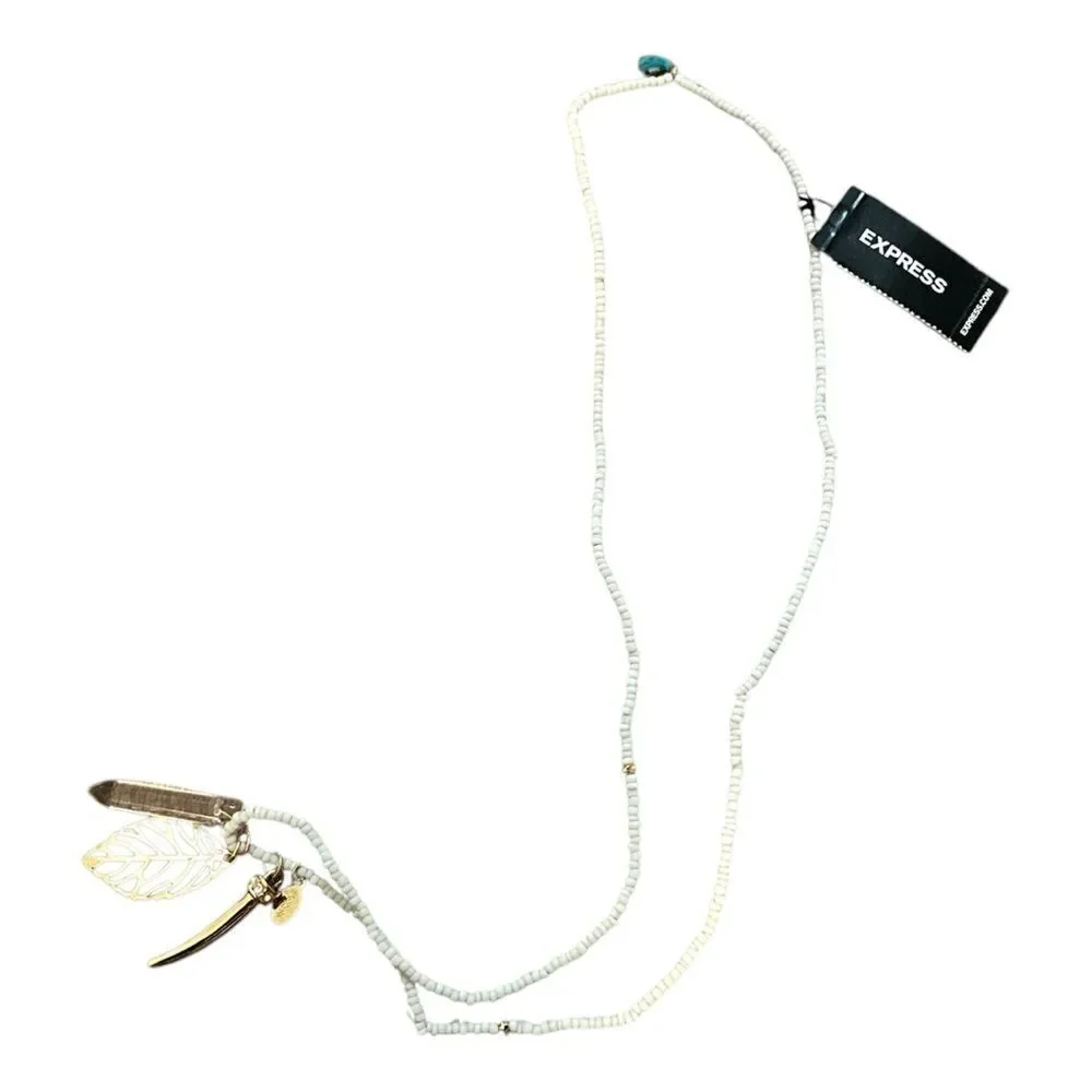 Express white beaded necklace with gold tone pendants. NWT